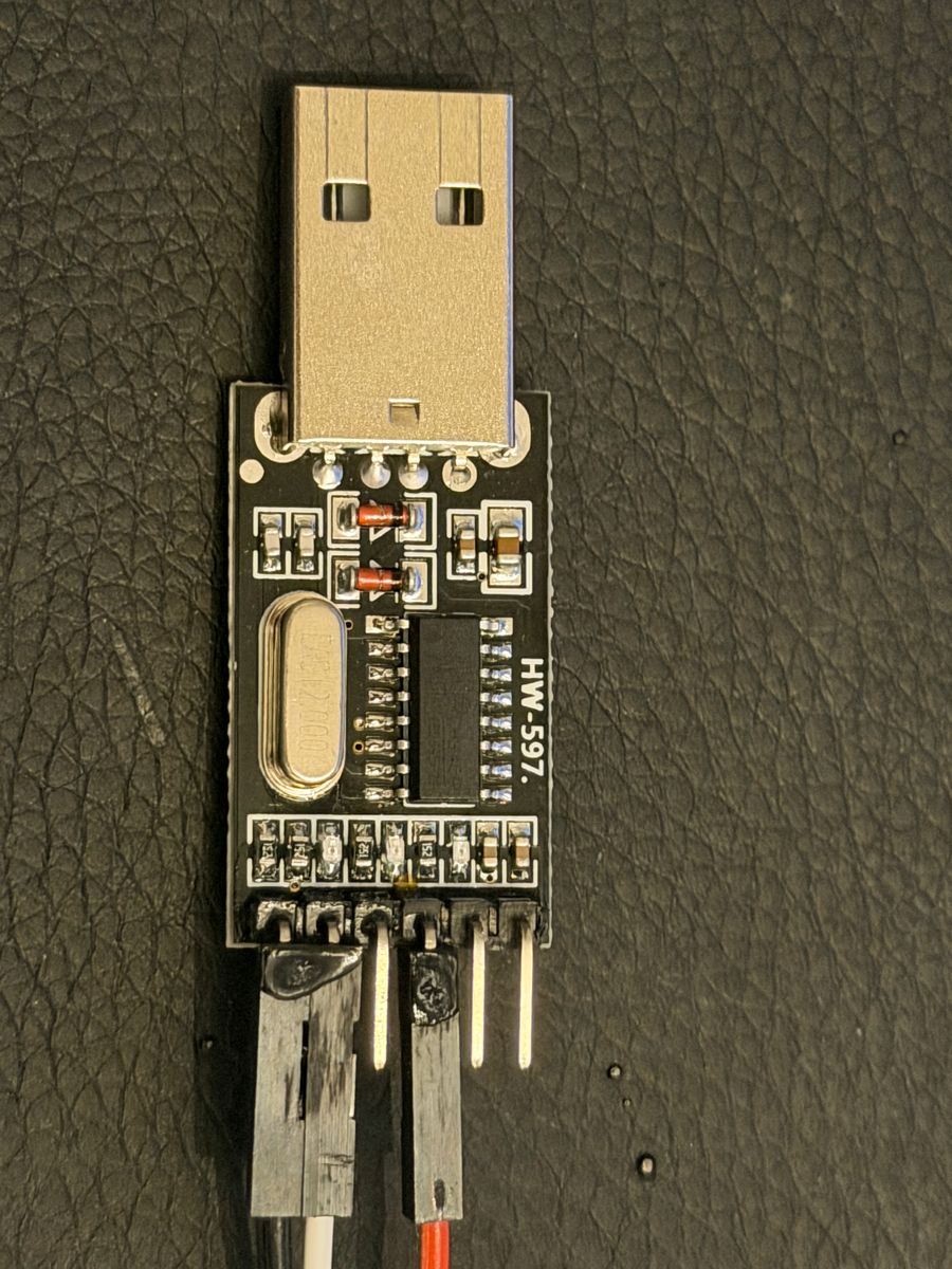 Component side of the CH340 adapter, marking HW-597, with jumper wires on its header