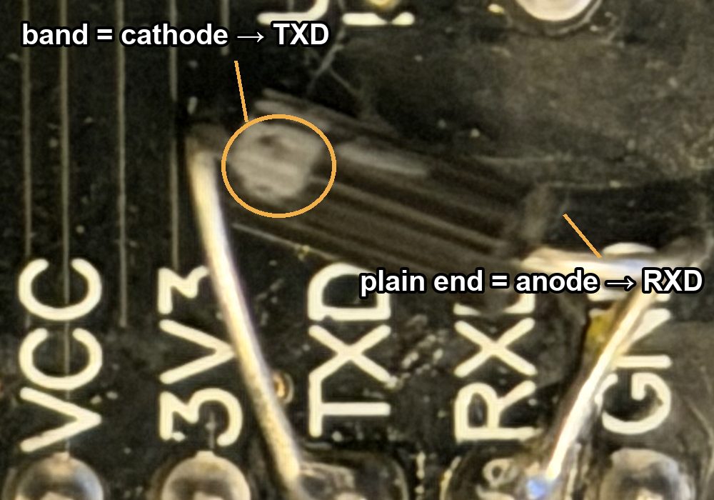 Close-up of the diode: the banded end is wired to the TXD pad, the plain end to the RXD pad