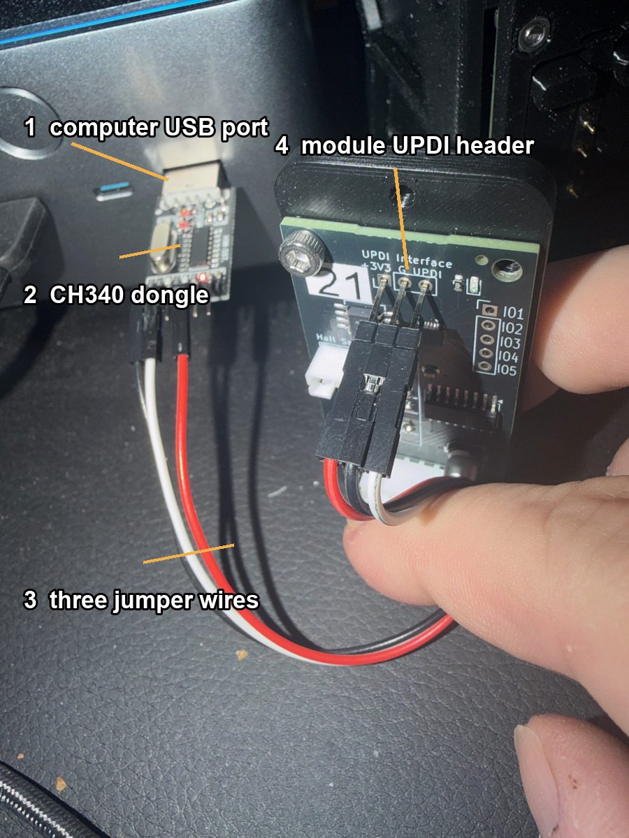 Mini PC with the CH340 adapter in its USB port, three jumper wires running to the UPDI header of a split-flap module